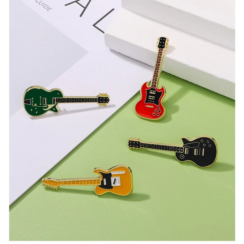 Set of four enamel electric guitar brooches in green red black and orange with gold trim for personalized fashion use