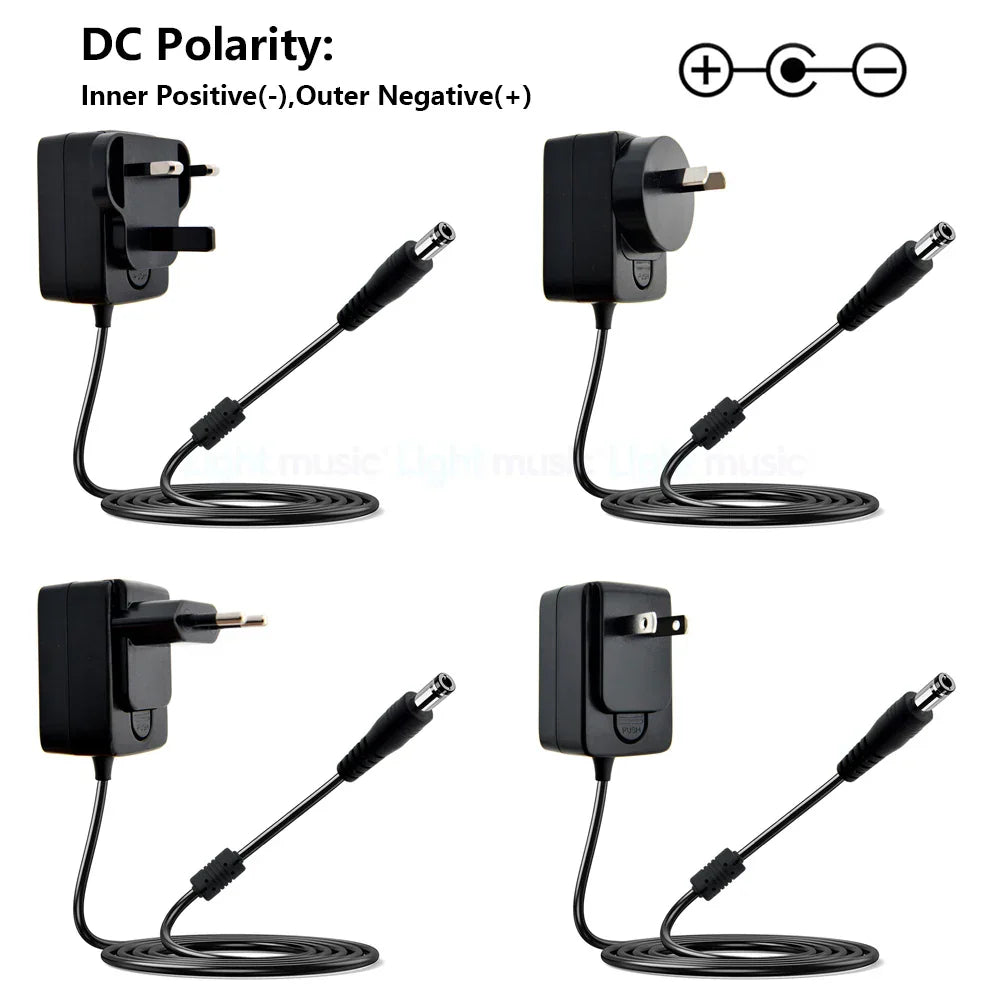 Black plastic electric guitar pedal power adapters with coiled cables and international plugs for vintage overdrive use