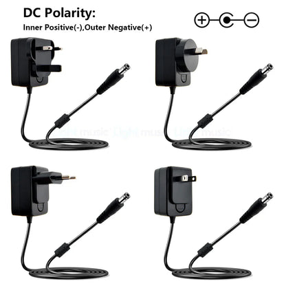 Black plastic electric guitar pedal power adapters with coiled cables and international plugs for vintage overdrive use