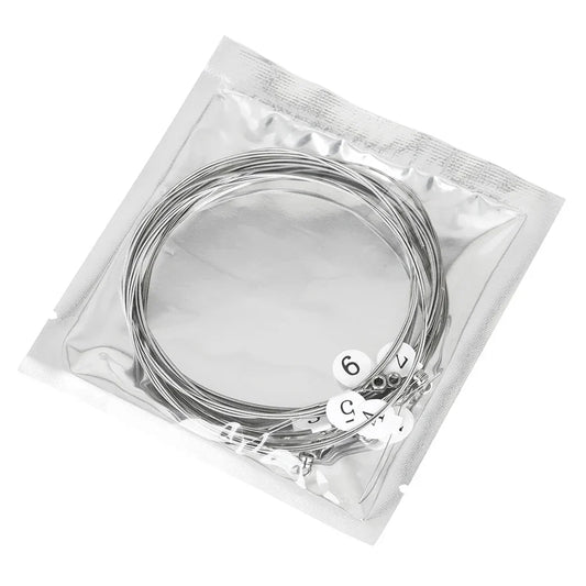 Silver electric guitar strings made of nickel alloy in clear plastic bag with white numbered labels for musical instruments accessories