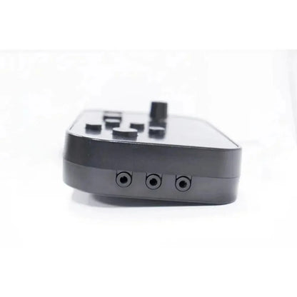 Black matte plastic gaming controller with multiple buttons and three circular ports for electronic drum kit mt10 usb midi headphone use