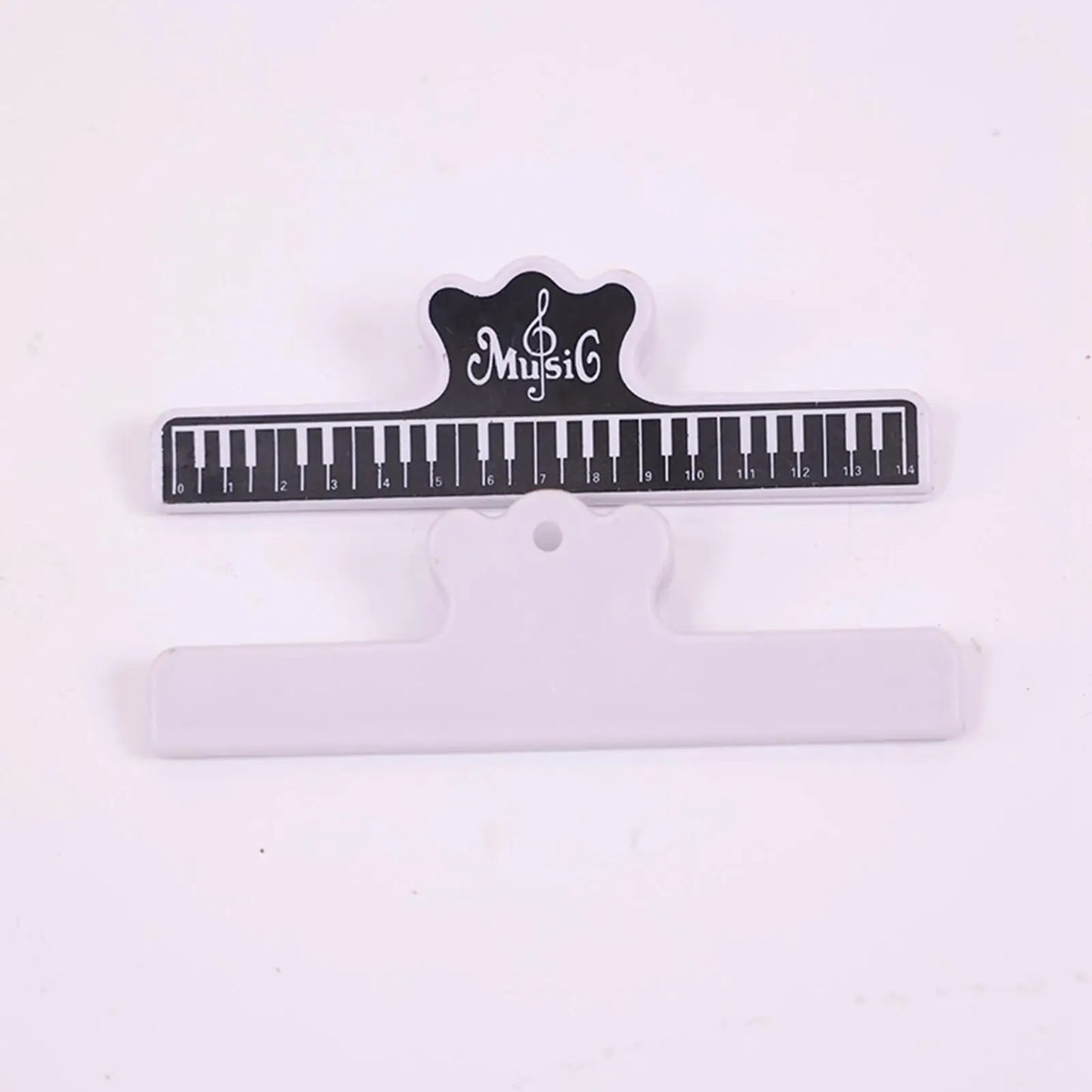 Electronic piano music stand with black and white piano-key clip and crown-shaped music logo for sheet music display