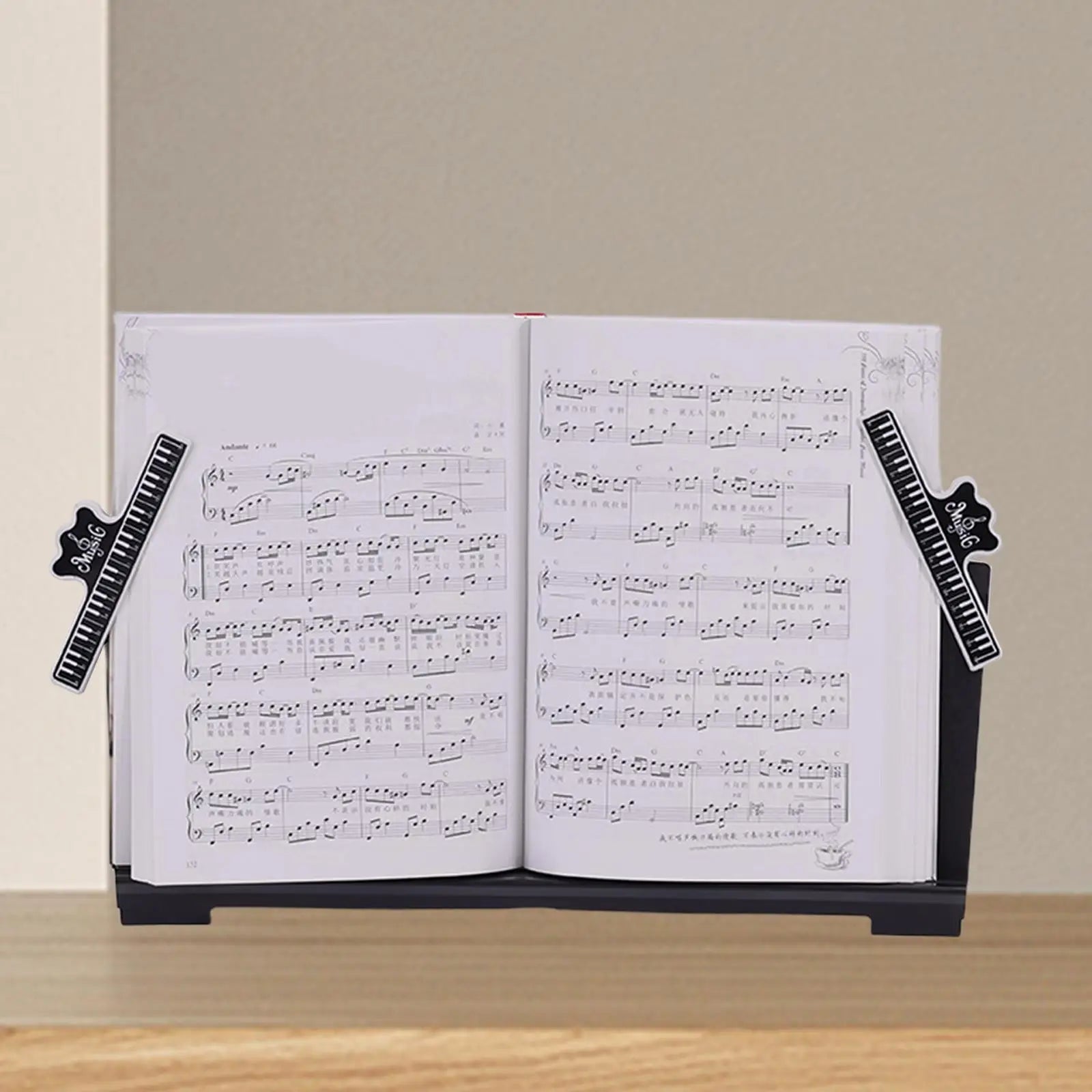 Black electronic piano music stand with crown-shaped sheet music clips for keyboard book holding and storage