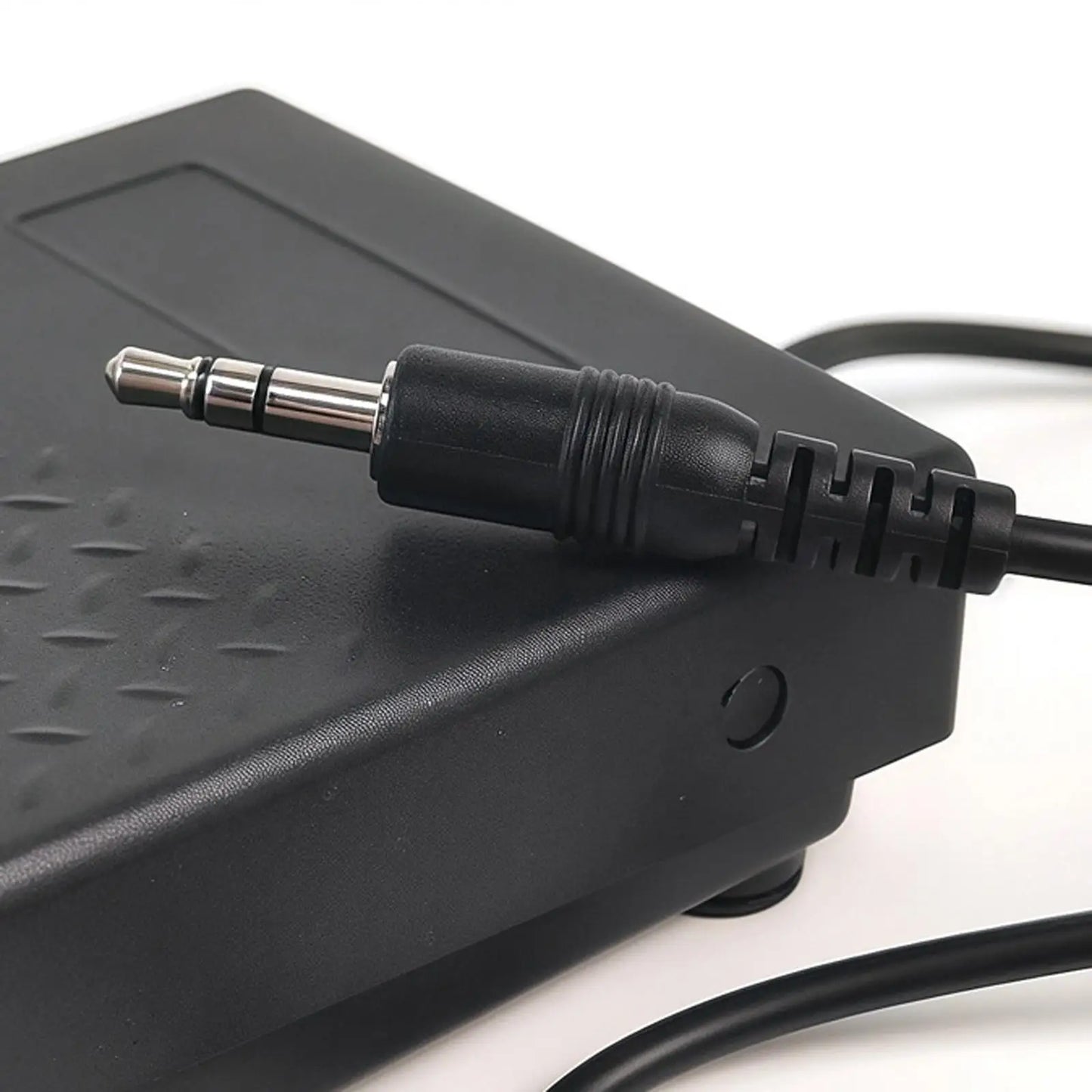 Black plastic piano sustain pedal with textured surface and 3.5mm jack cable for synthesizers sturdy music use