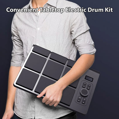Black rectangular electronic tabletop drum set with silver trim supports bt midi and features 9 color pads and 2 speakers