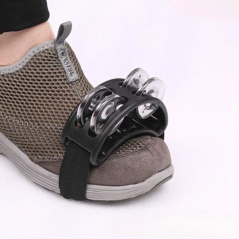 Black plastic elliptical drum companion musical educational tambourine with silver jingles attached to gray mesh sneaker