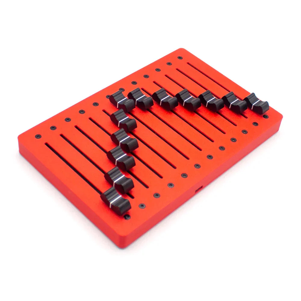 Red rectangular metal panel of em-12f motor fader midi controller with black toggle switches and faders usb plug features