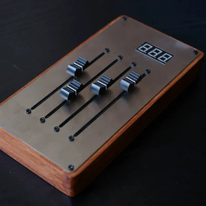 Rectangular wooden midi controller mixer with brushed metal faceplate and four black sliding faders mixing console automatically maps unlimited page turning
