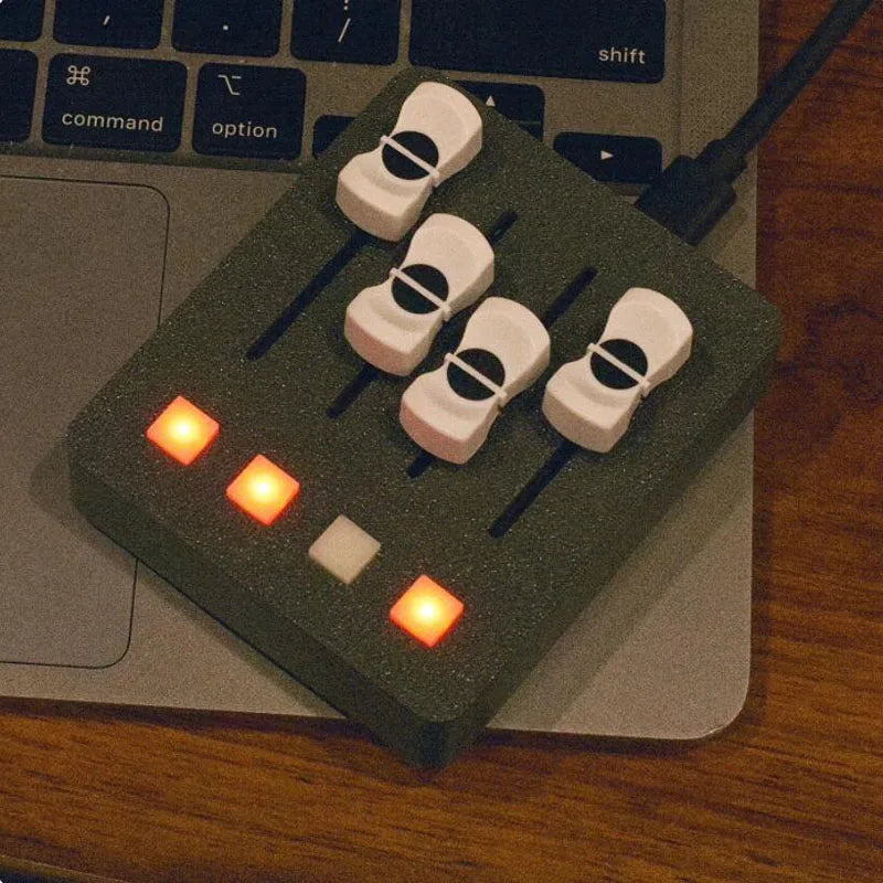 Dark green foam-mounted em-po2 midi controller with four white violin-shaped faders and customizable backlit buttons for streaming control