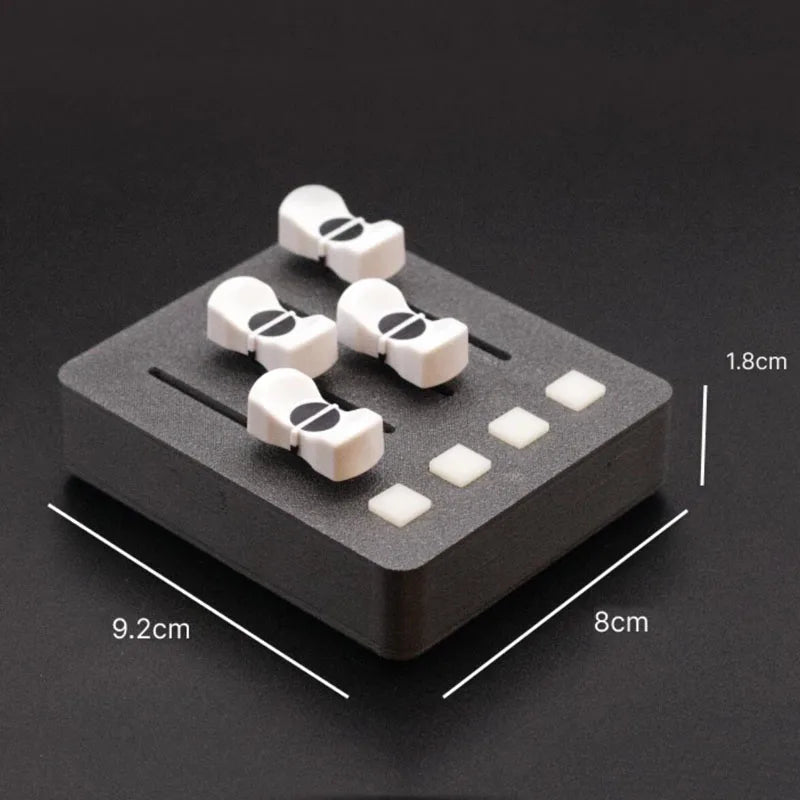 White plastic toggle clasps with black accents on dark foam base for em-po2 midi controller streaming control use