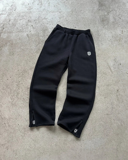 Black embroidered sweatpants with subtle white logo and matching cuffs in set y2k clothing oversized sweatpants casual style