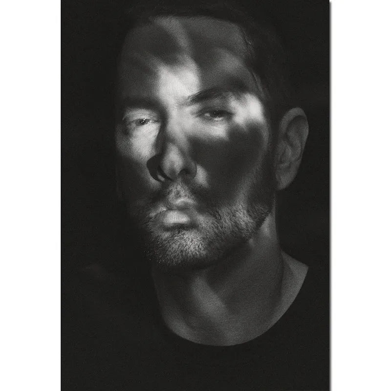 A monochromatic charcoal eminem poster featuring intense eyes and stubble printed on canvas for home decor