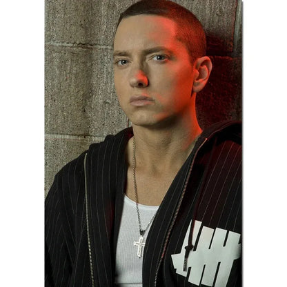 Silver cross pendant necklace with chain worn by person shown with eminem posters 8 mile canvas wall art decor