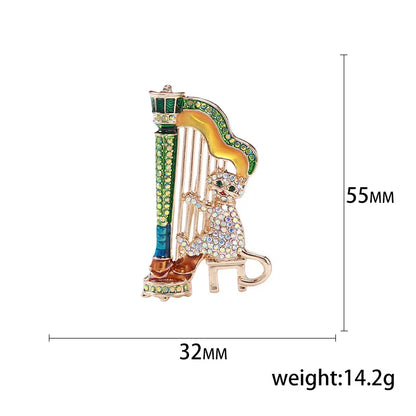 A sparkling gold-toned harp-shaped enamel violin brooch with green blue yellow accents and rhinestones for banquet party backpack gifts