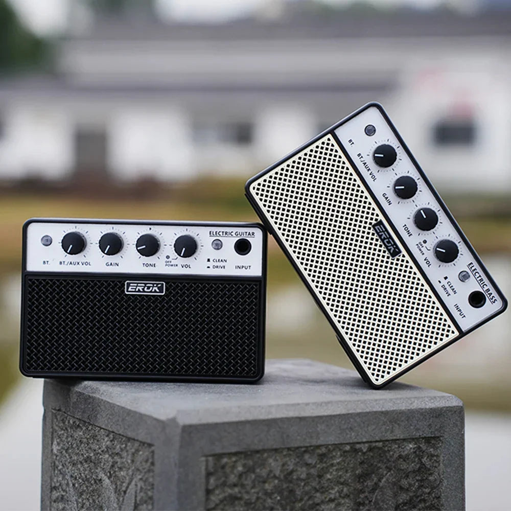 Black and white erok guitar portable bass mini amplifier with textured grille and clean drive effects controls