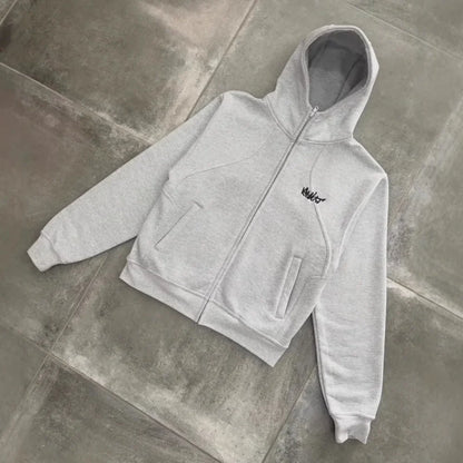 A light gray men’s hip-hop style zip-up hoodie with a small black embroidered logo on the left chest
