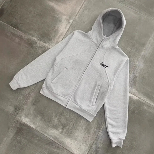 A light gray men’s hip-hop style zip-up hoodie with a small black embroidered logo on the left chest