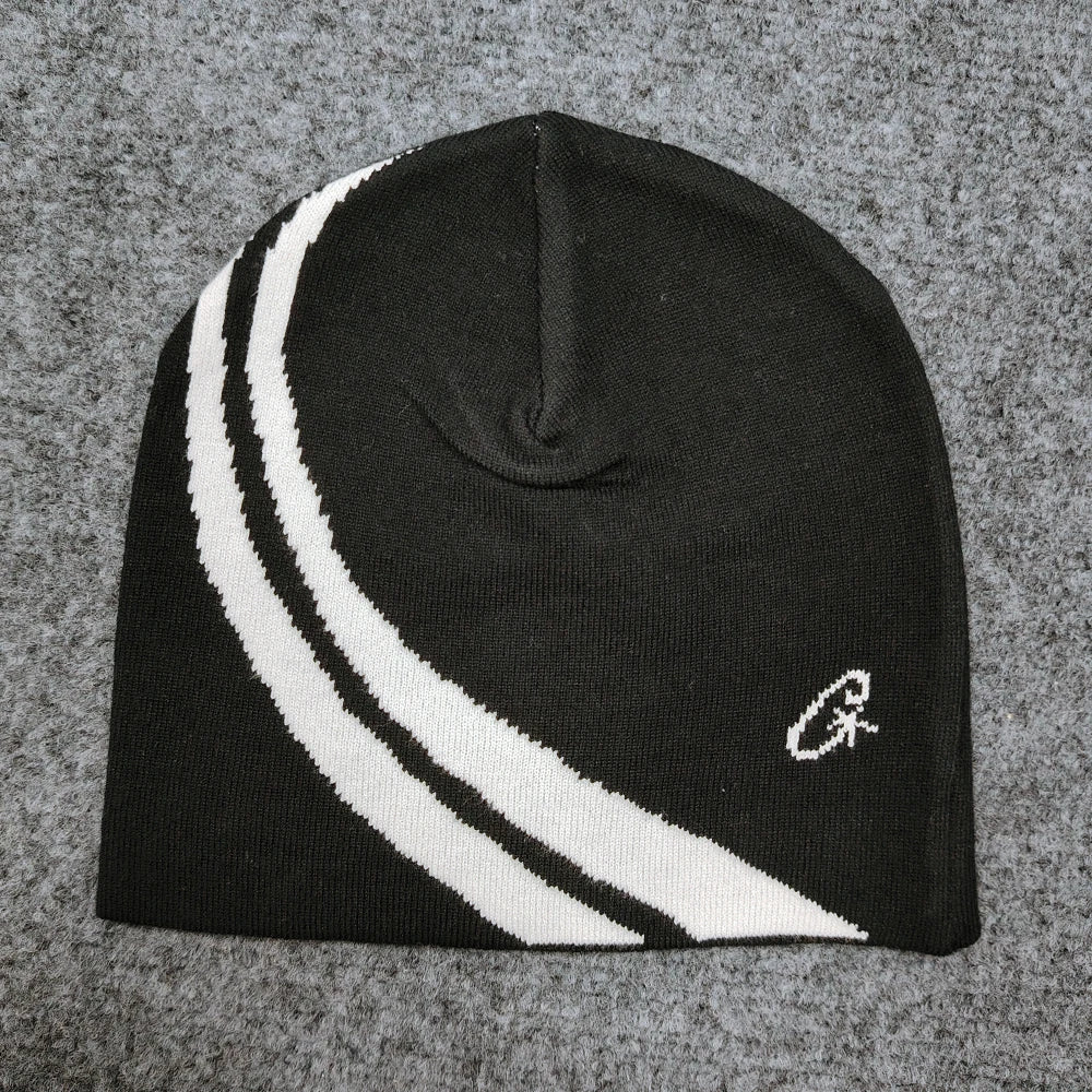 Black knit beanie with two bold white diagonal stripes and small embroidered logo, a trendy hip-hop casual pullover hat