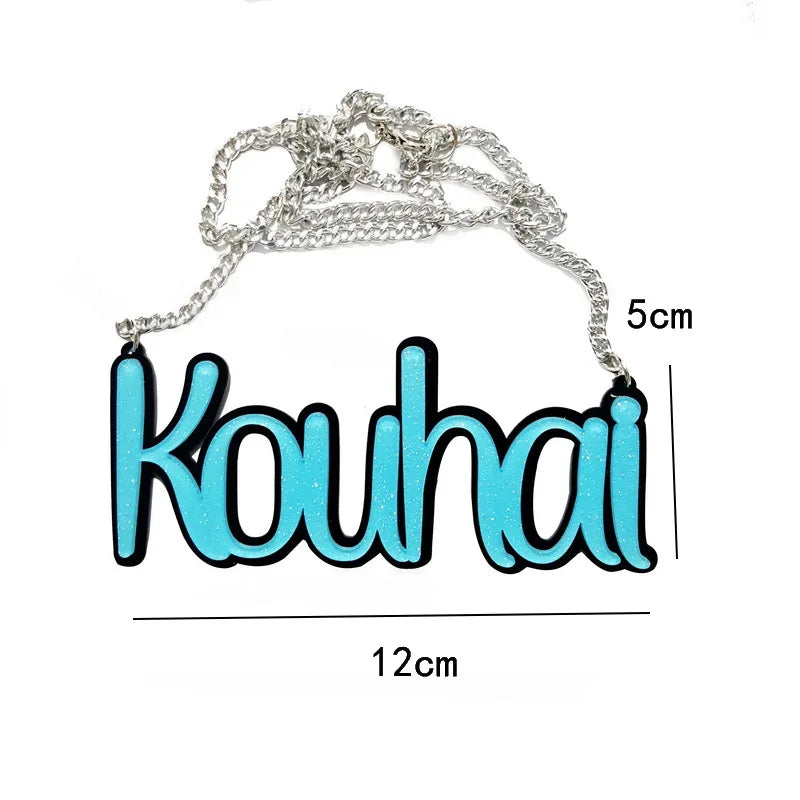 A turquoise glittery kouhai nameplate necklace with black letter halloween outline on silver chain for necklace street trend