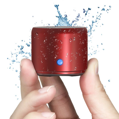 Red cylindrical ewa a106pro mini bluetooth speaker with blue power button splashing water ipx7 waterproof design and play time