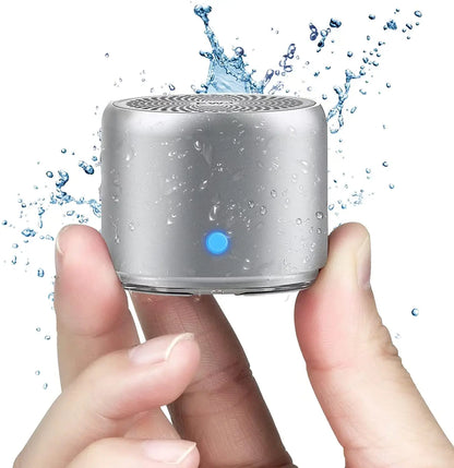 Silver cylindrical a106pro mini bluetooth speaker with blue power light ipx7 waterproof design and long play time