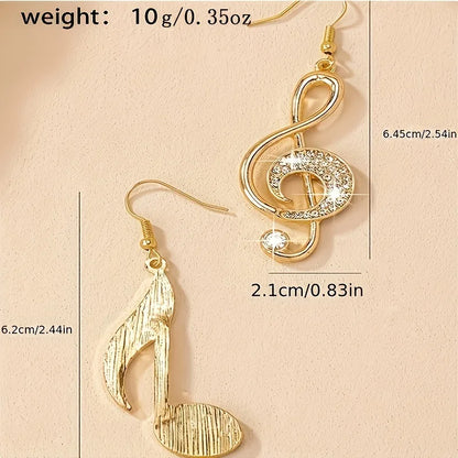 Gold-colored rhinestone musical note pendant drop earrings featuring a sparkling treble clef and textured eighth note design