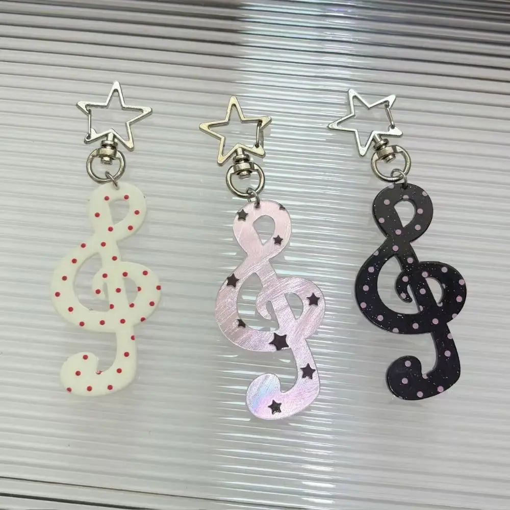 Three fashion cartoon acrylic musical note keychains with star clasps and polka dots in red black and white kawaii style