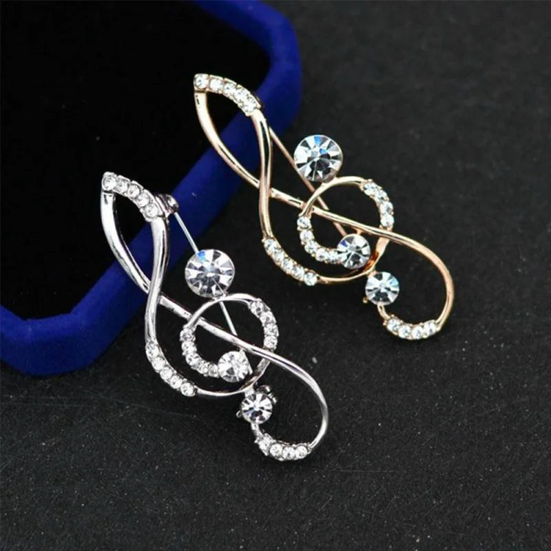 Two fashion crystal broochs shaped as rhinestone music notes in silver and gold tone perfect as wedding pin gifts