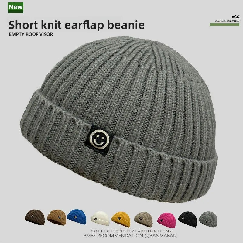 Gray short knit hip hop beanie with ribbed texture and black smiley face patch for men skullcap women winter warm brimless wear