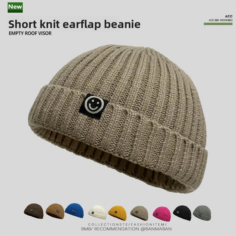 Beige ribbed knit hip hop beanie with black smiley face patch winter warm brimless men skullcap women hat