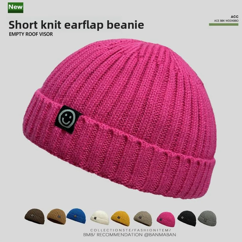 Vibrant pink hip hop beanie knitted hat men skullcap women winter with ribbed texture and black smiley face patch