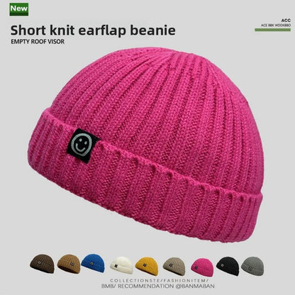 Vibrant pink hip hop beanie knitted hat men skullcap women winter with ribbed texture and black smiley face patch