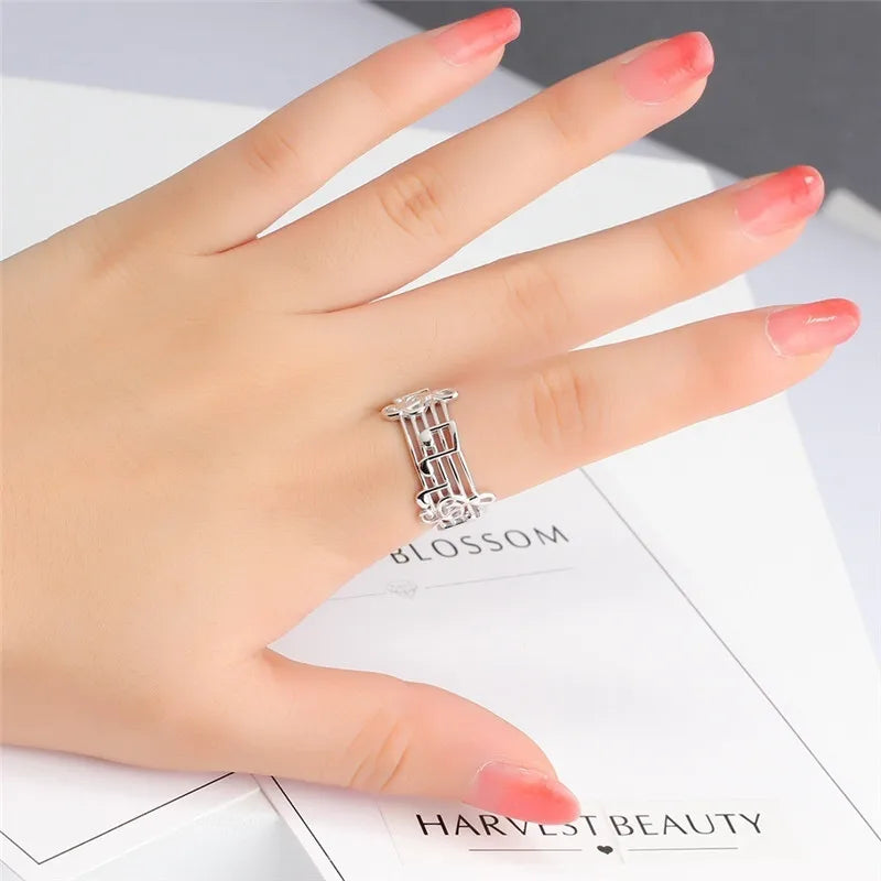 A delicate silver musical note ring with an intricate floral design and stones for female music lovers and wedding party music
