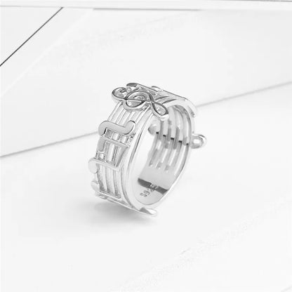 Silver musical note ring with intricate staff design and polished metallic finish for female music lovers wedding party music