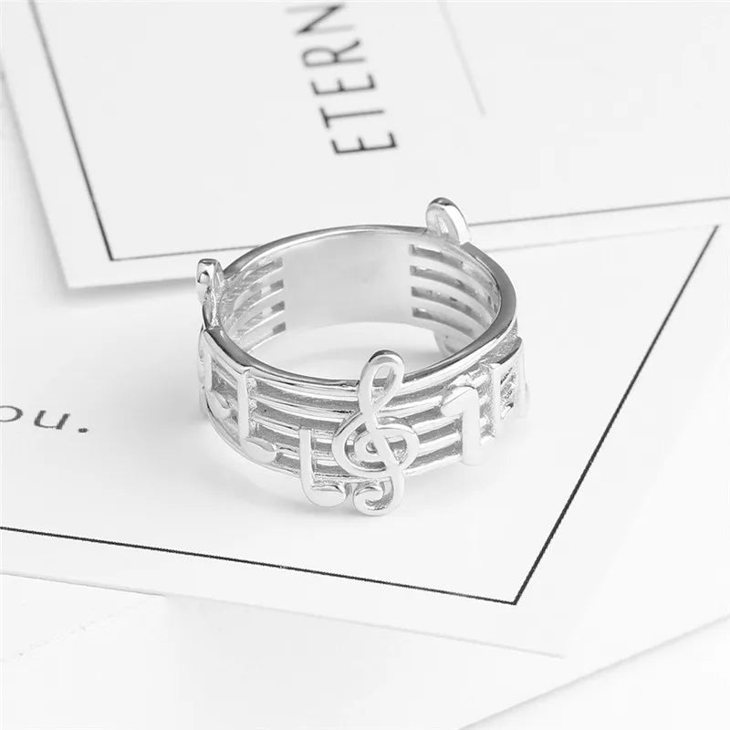 Silver musical note ring with treble clef design and engraved staff lines for female music lovers wedding party music