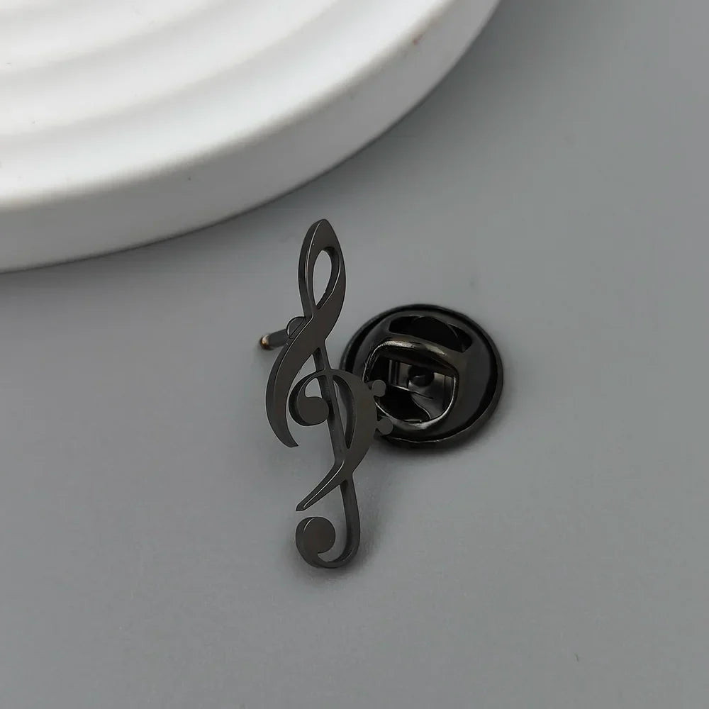 Black metal treble clef music symbol brooch with polished finish and circular clasp backing for symbol music lover accessories