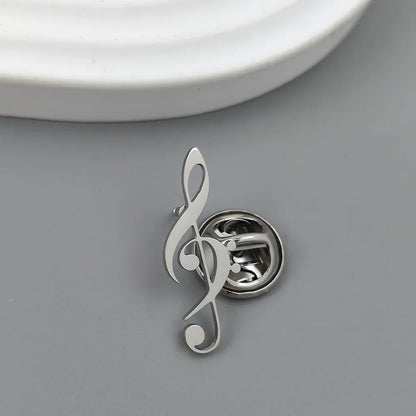 Silver metallic treble clef music symbol brooch with polished stainless steel finish for fashionable music lover accessories