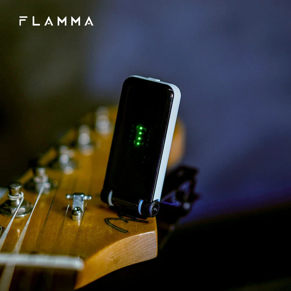 Flamma ft01 clip-on tuner with sleek black and white design and glowing green led indicators for acoustic guitar bass instruments christmas gift