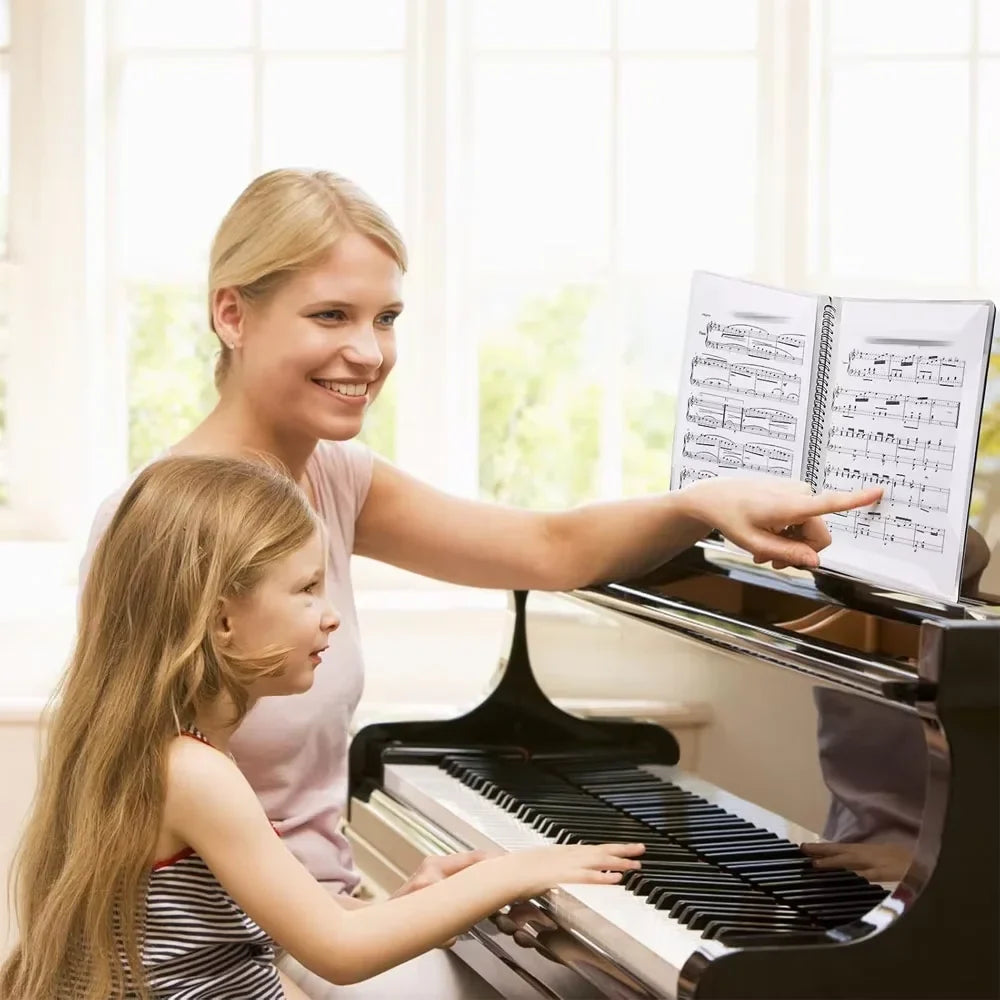 Black grand piano with polished wooden keys and glossy finish shown alongside flexible 40 pages piano music score folder