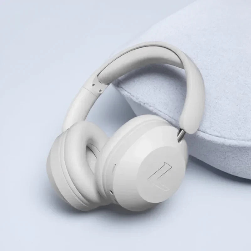 Cream-colored foldable wireless bluetooth over-ear sports headphones with high power stereo sound and soft padded earcups