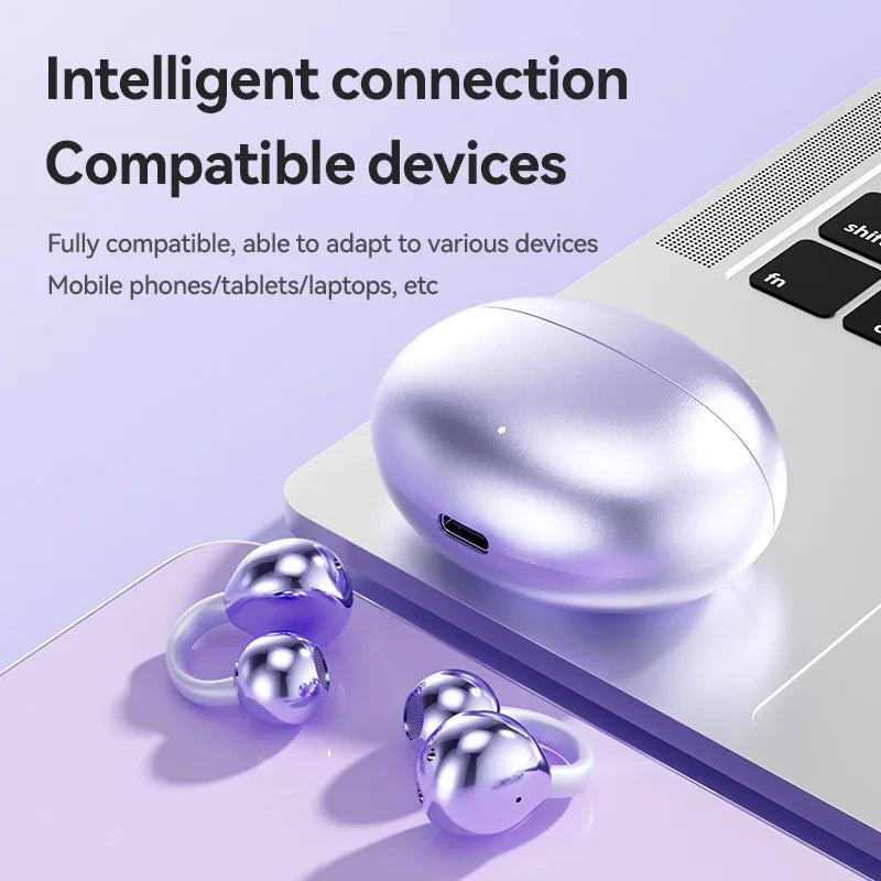 Silver metallic wireless bone conduction headphones clip with spherical design and matching case beside laptop for sports gaming earphone use