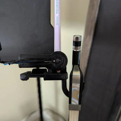 Black plastic folding bow hook desk clamp holding a pencil and electronic device for bow holder organizer