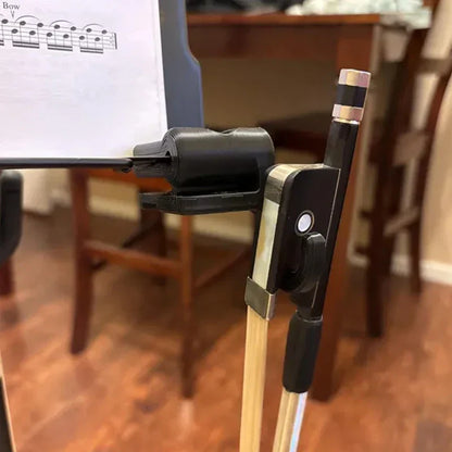 Black and silver violin bow with wooden stick resting in a black folding bow hook bow holder organizer for music stand