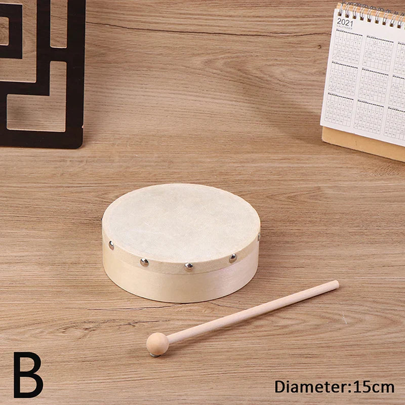 A round cream-colored wooden frame drum with beige leather head and silver tuning lugs with drum stick set kids educational toy