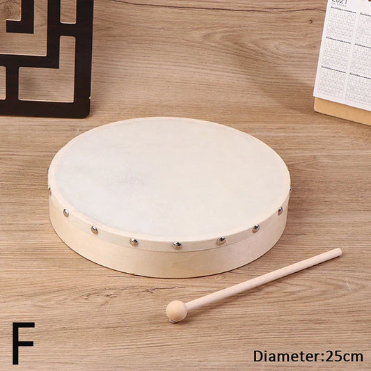 A round off-white frame drum with wooden frame and silver metal studs featuring a drum stick set kids educational toy