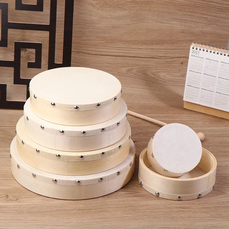 Set of four cream-colored wooden frame drums with white drumheads and drum stick set kids educational toy