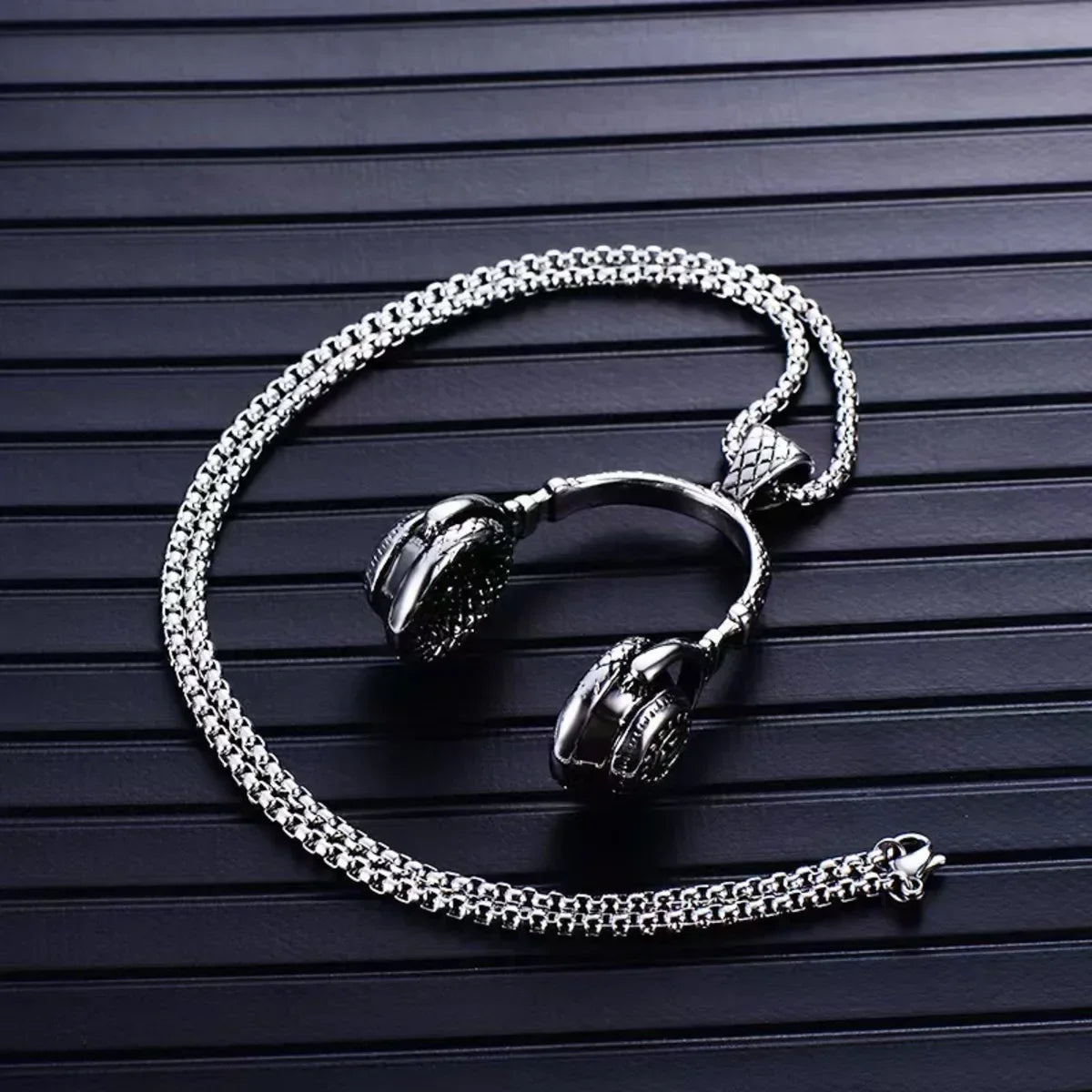 Silver-toned stainless steel music headphone pendant necklace with detailed textured fan dj music design and blackened accents