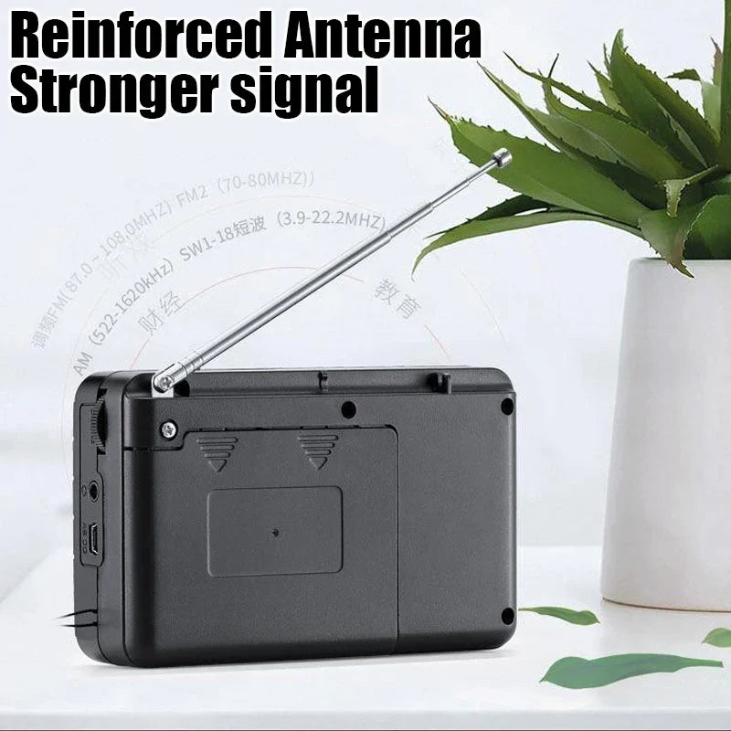 Black plastic band radio portable with silver telescopic antenna extended and 3.5mm headphone jack receiver rechargeable radio