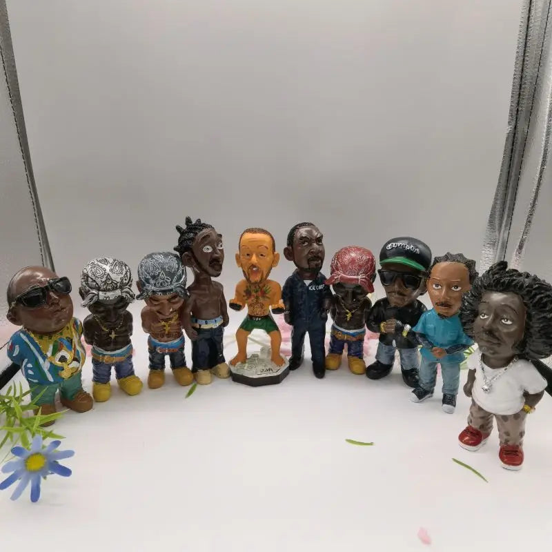 A colorful collection of resin statue bobbleheads depicting hip hop rapper funny bro figurines for indoor outdoor decor