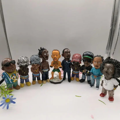 A colorful collection of resin statue bobbleheads depicting hip hop rapper funny bro figurines for indoor outdoor decor